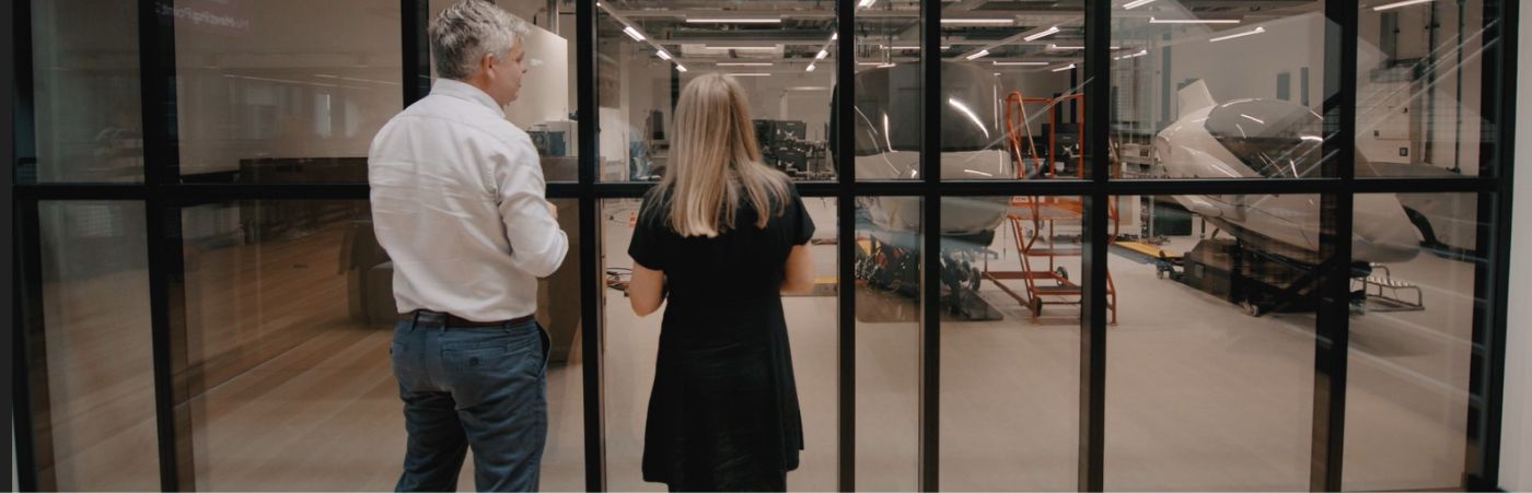 Scott Taylor and Lucy May looking at a lab in the Nancy Rothwell Building