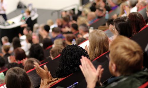 People clapping at a conference