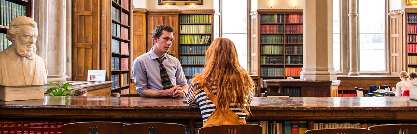 Two people talking in Christie Bistro